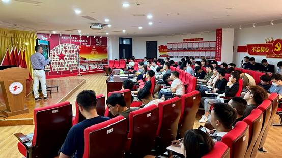 A group of people sitting in a room

Description automatically generated