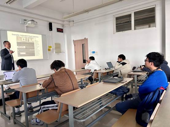 A group of people sitting in a classroom
Description automatically generated